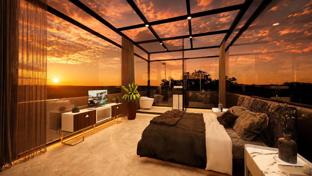 Interior of a glass resort suite at sunset